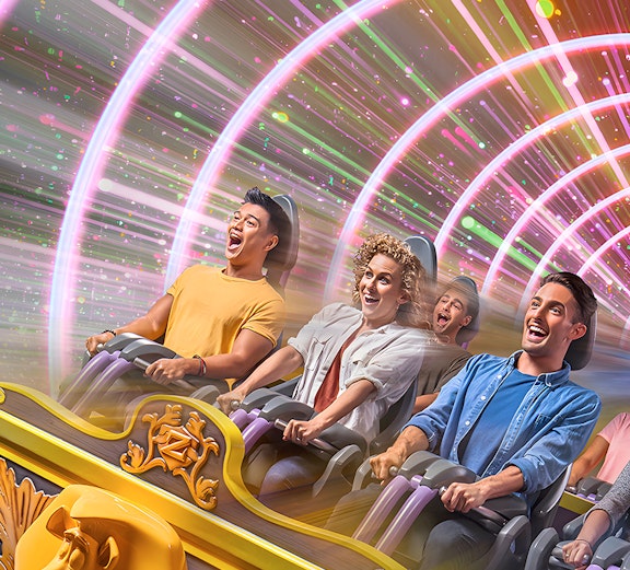 People enjoying a thrilling roller coaster ride with colorful light tunnel.