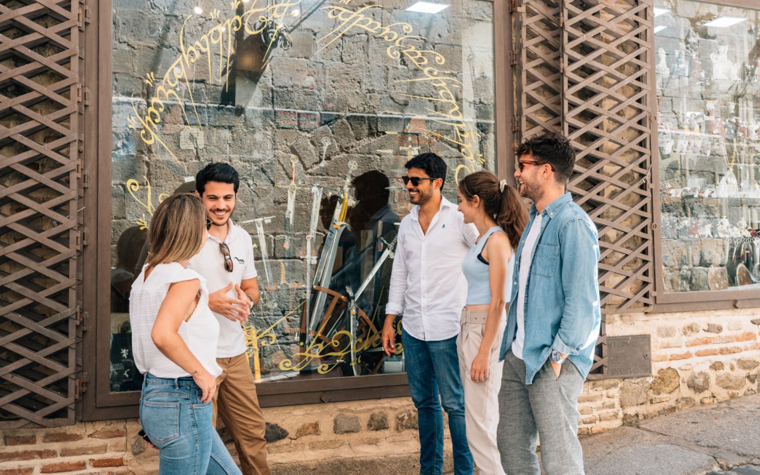 Friends with guide exploring historic Toledo streets.