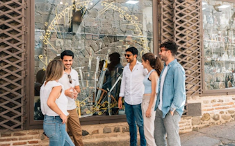 Friends with guide exploring historic Toledo streets.
