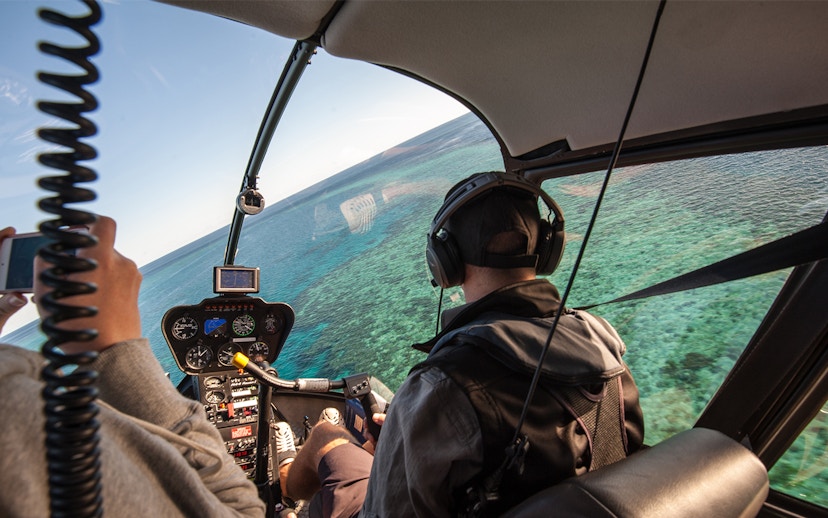 Helicopter cockpit view over the Great Barrier Reef, Australia.