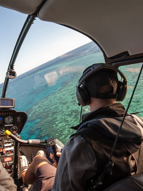 Helicopter cockpit view over the Great Barrier Reef, Australia.