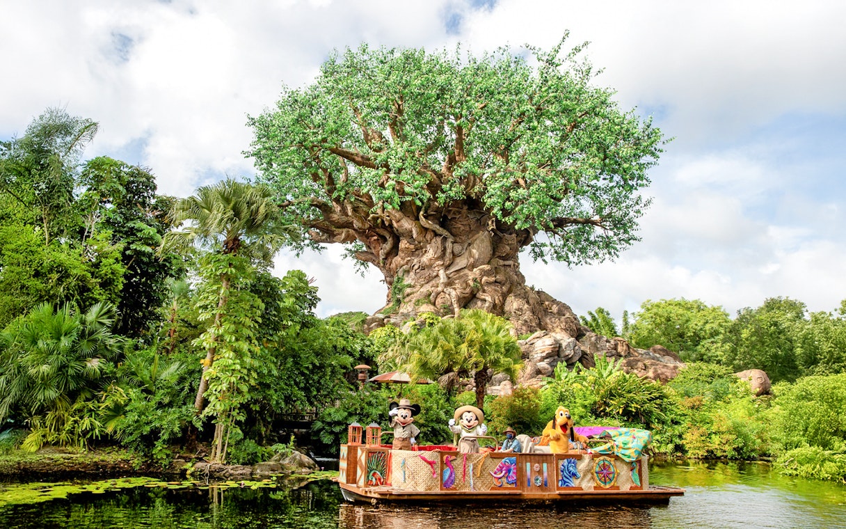 Characters on a boat in front of the Tree of Life at Animal Kingdom, Orlando.
