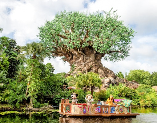 Characters on a boat in front of the Tree of Life at Animal Kingdom, Orlando.