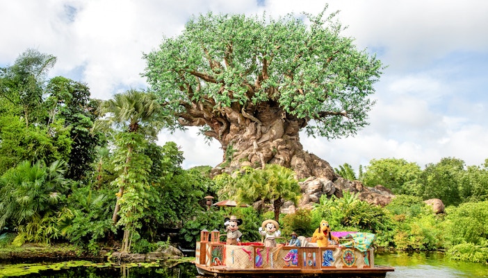 Characters on a boat in front of the Tree of Life at Animal Kingdom, Orlando.
