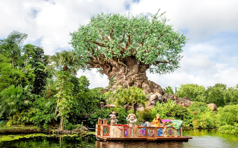 Characters on a boat in front of the Tree of Life at Animal Kingdom, Orlando.