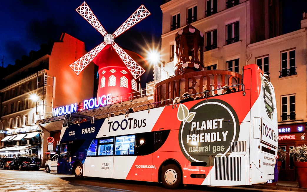 Tootbus in front of Moulin Rouge during a Paris night tour.