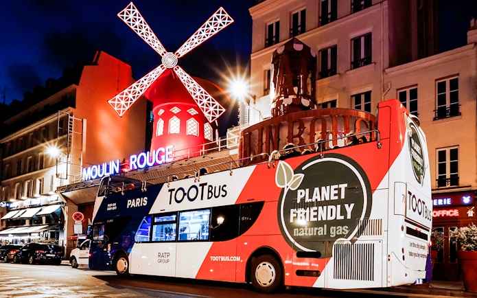 Tootbus in front of Moulin Rouge during a Paris night tour.
