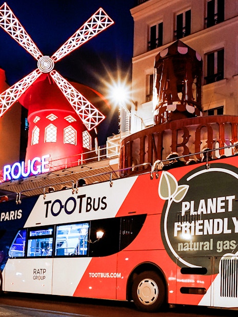Tootbus in front of Moulin Rouge during a Paris night tour.