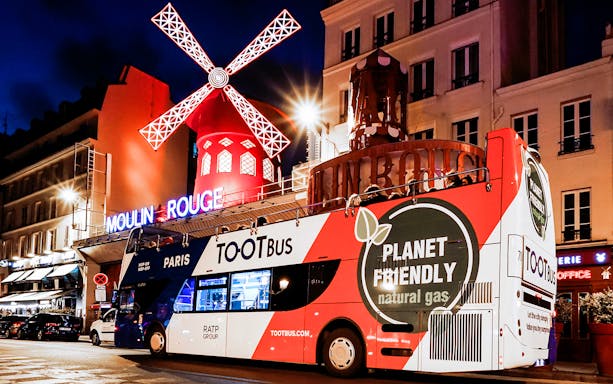 Tootbus in front of Moulin Rouge during a Paris night tour.