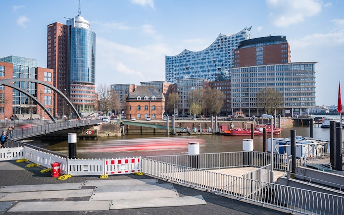 Elbphilharmonie in Hamburg with surrounding modern buildings and a bridge over the river.