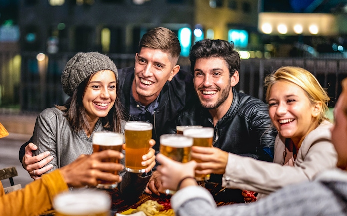 Group of friends toasting with beer during a 3-hour beer tour.