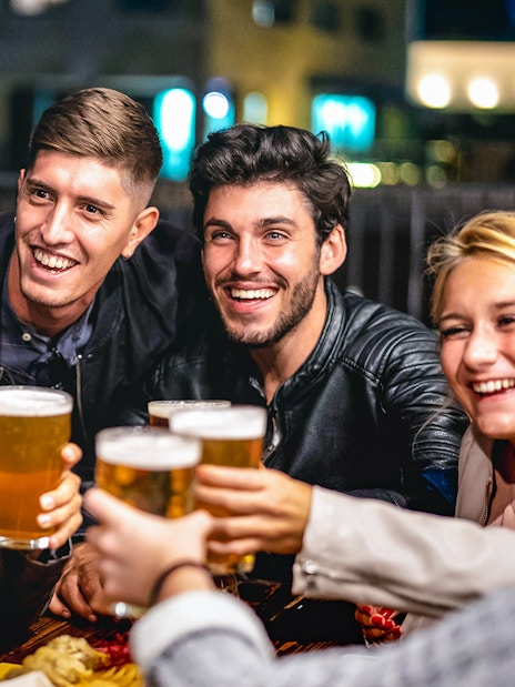 Group of friends toasting with beer during a 3-hour beer tour.