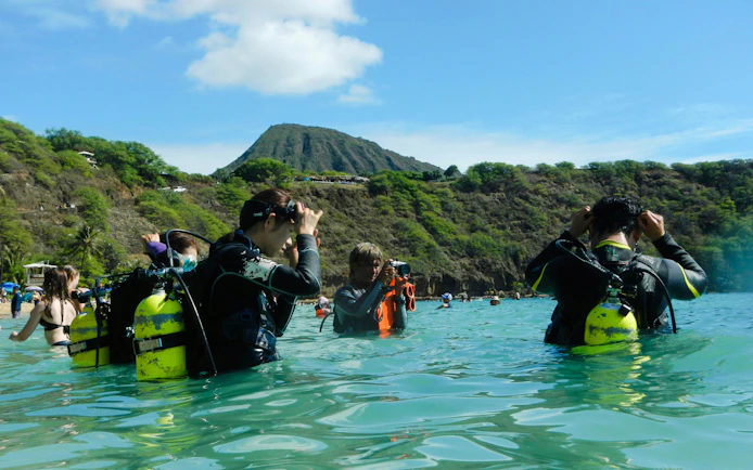 Snorkelers preparing in the water at Hanauma Bay Nature Preserve, Hawaii.
