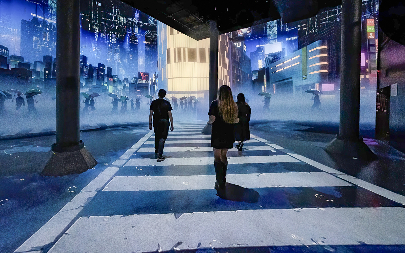 Guests walking through digital cityscape exhibit at ARTECHOUSE New York.