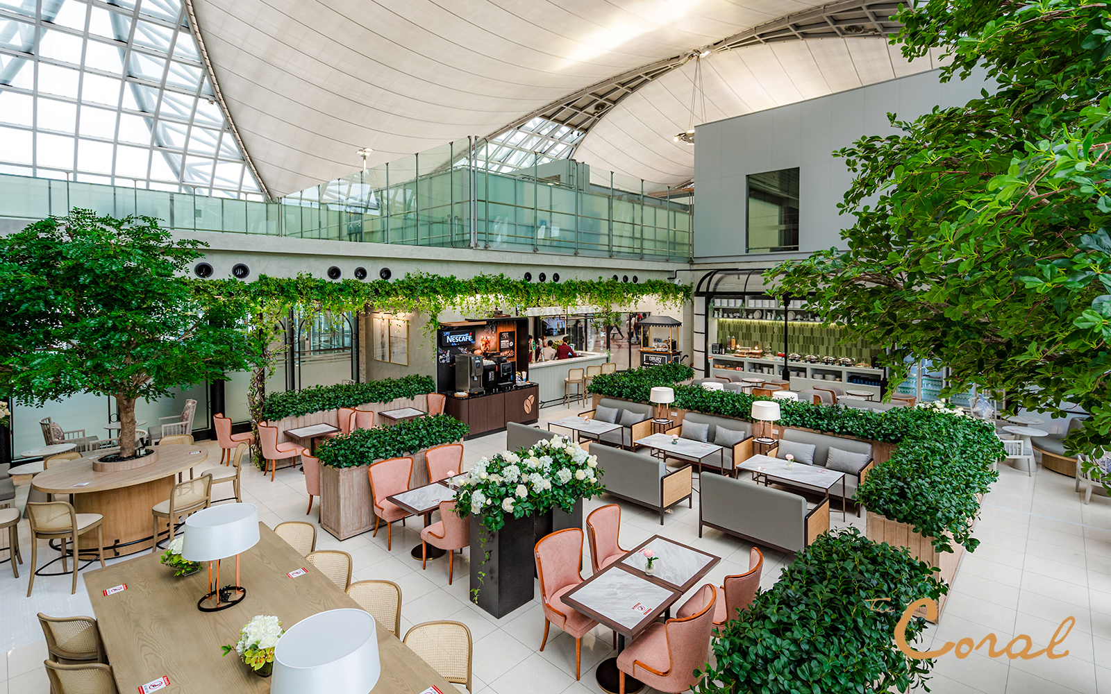 Coral Executive Lounge seating area with greenery, Bangkok airport, Thailand.