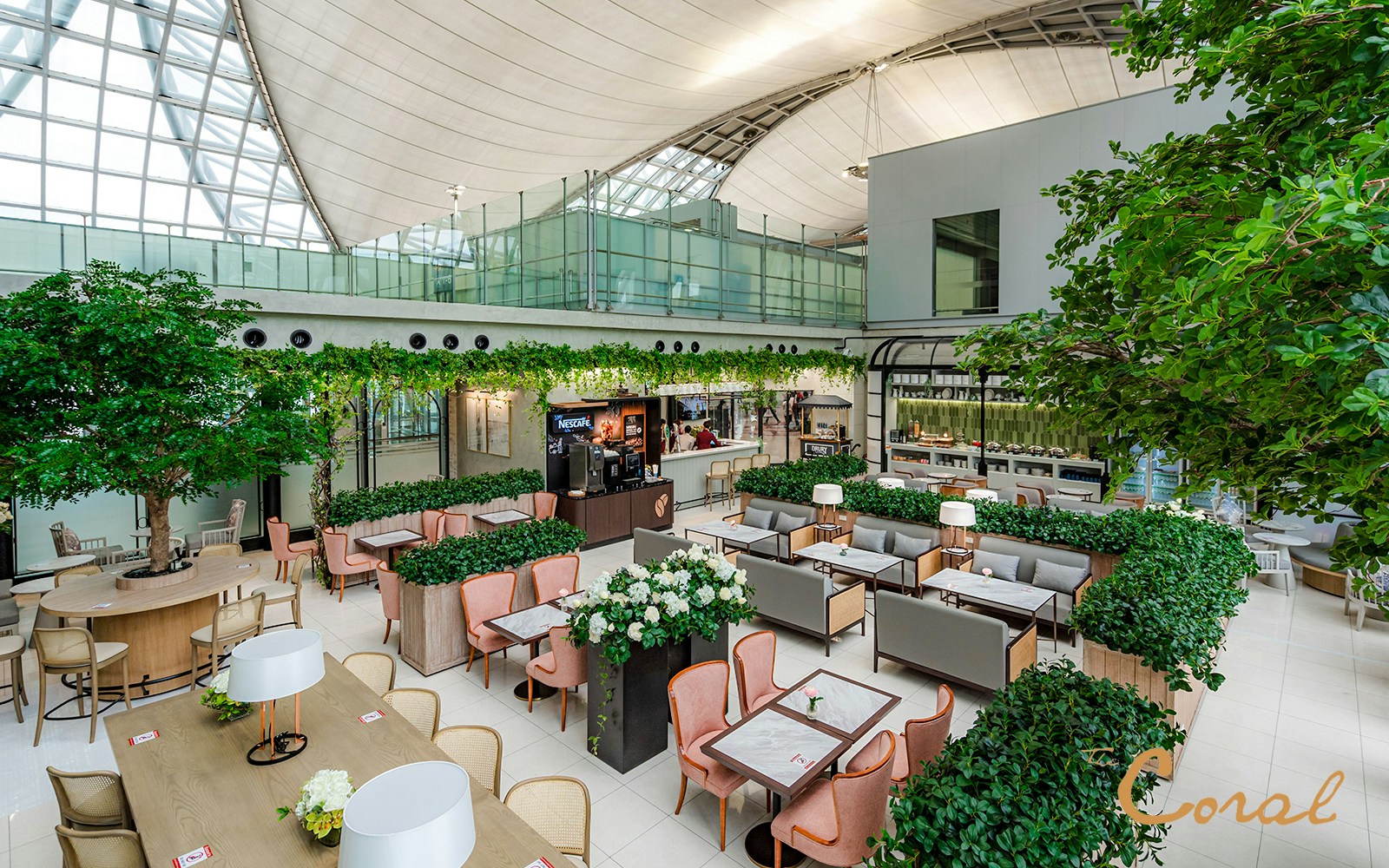 Coral Executive Lounge seating area with greenery, Bangkok airport, Thailand.