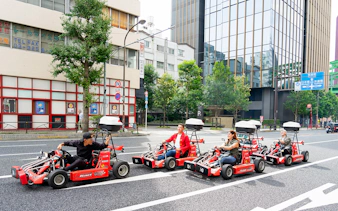 People driving go-karts on Akihabara streets in Tokyo.