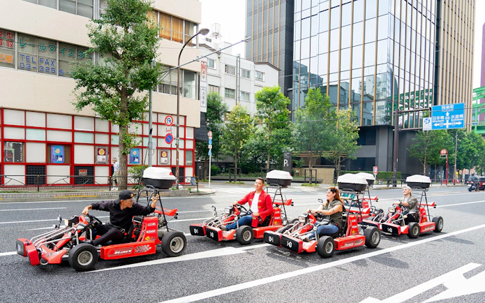 People driving go-karts on Akihabara streets in Tokyo.