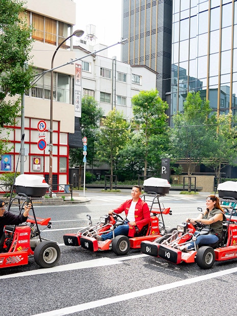 People driving go-karts on Akihabara streets in Tokyo.