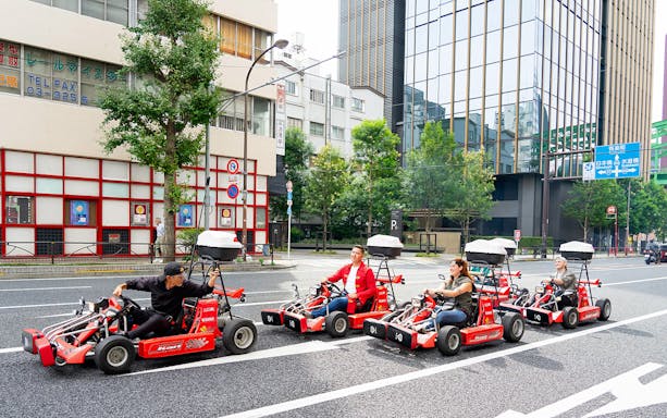 People driving go-karts on Akihabara streets in Tokyo.