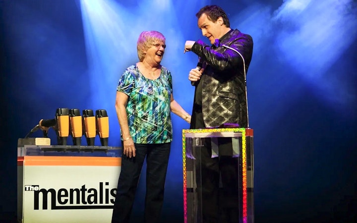 Performer interacting with audience member during The Mentalist show.