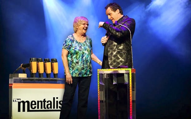 Performer interacting with audience member during The Mentalist show.