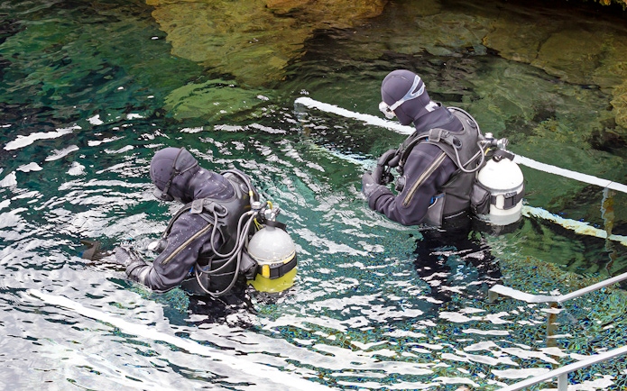 Snorkelers entering Silfra Fissure in Iceland.