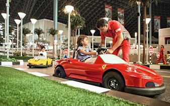 Children driving toy Ferrari cars at Ferrari World Abu Dhabi.