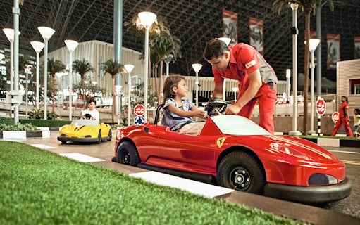 Children driving toy Ferrari cars at Ferrari World Abu Dhabi.