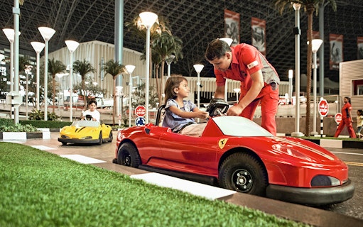 Children driving toy Ferrari cars at Ferrari World Abu Dhabi.