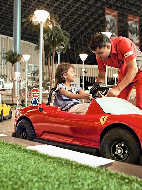 Children driving toy Ferrari cars at Ferrari World Abu Dhabi.