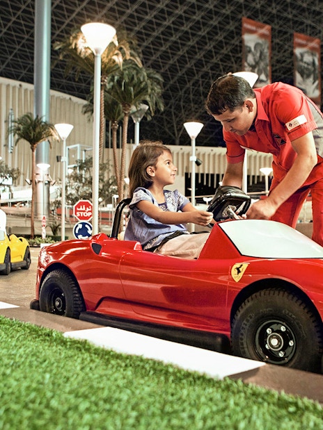Children driving toy Ferrari cars at Ferrari World Abu Dhabi.