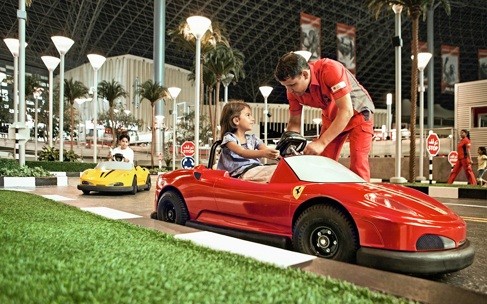Children driving toy Ferrari cars at Ferrari World Abu Dhabi.