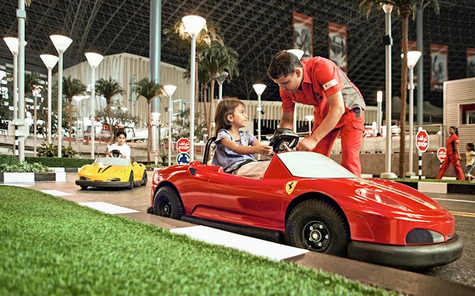 Children driving toy Ferrari cars at Ferrari World Abu Dhabi.