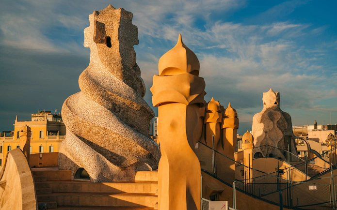 Rooftop chimneys of La Pedrera - Casa Milà at sunset in Barcelona.