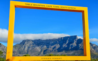 Table Mountain framed by a yellow border in Cape Town, South Africa.