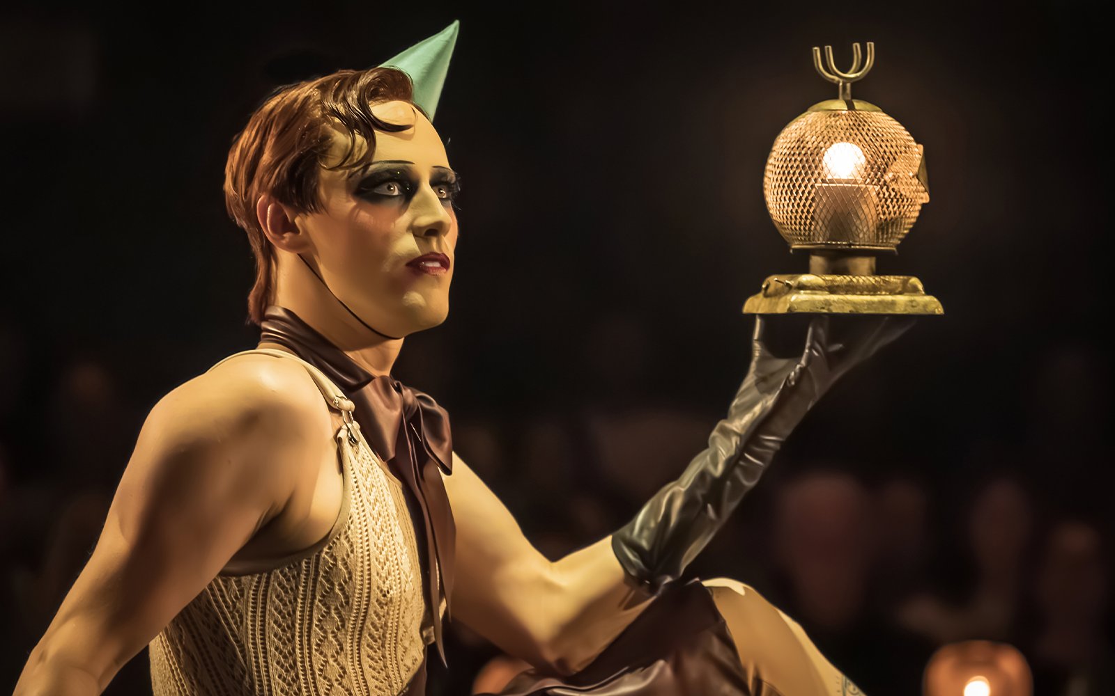 Performer holding a lit prop during Cabaret Westend show.