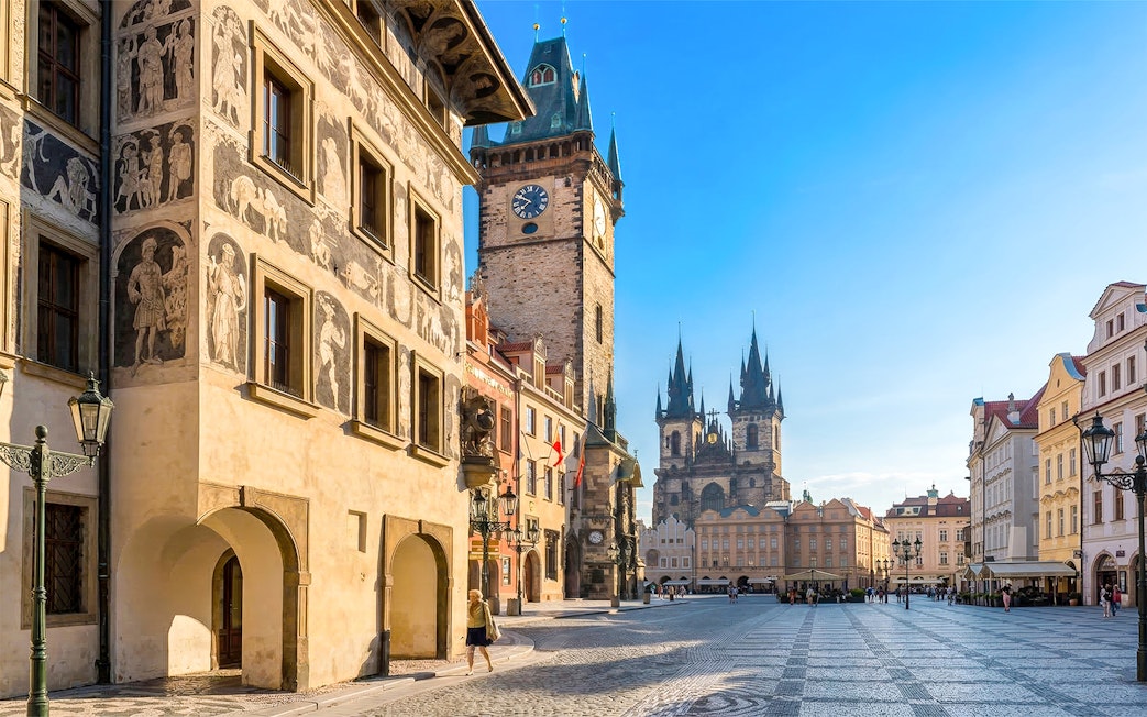 Prague Old Town Square with historic buildings and Tyn Church in the background.