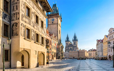 Prague Old Town Square with historic buildings and Tyn Church in the background.