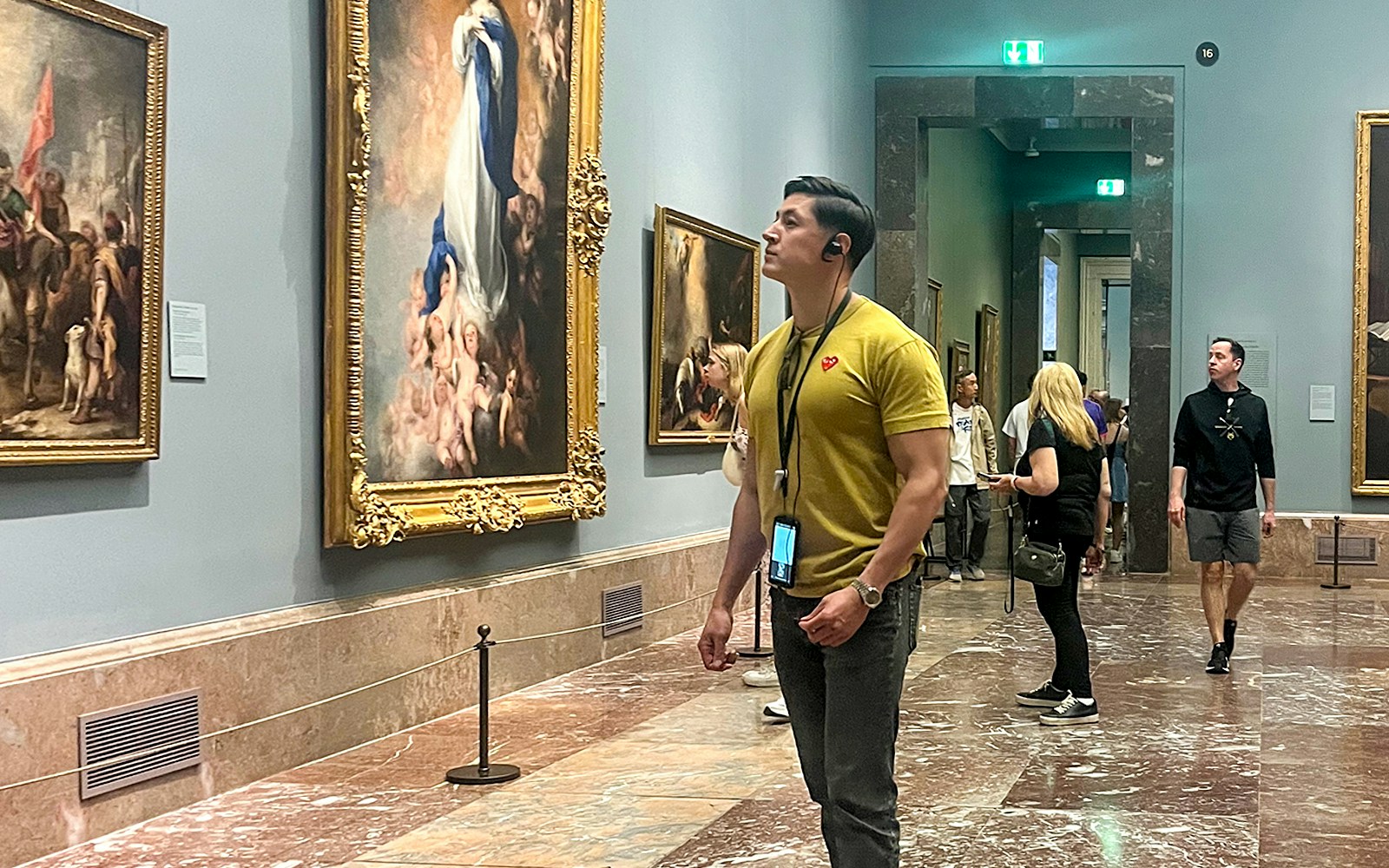 Visitors viewing artwork inside Prado Museum, Madrid.