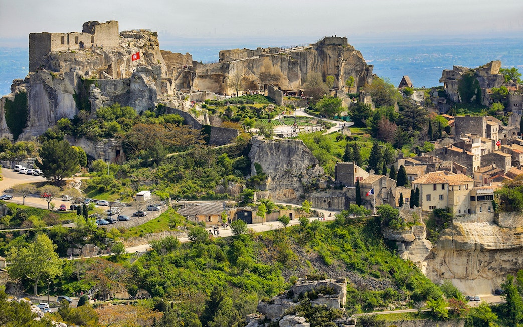 Les Baux de Provence village with ancient stone buildings and surrounding greenery.