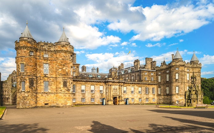Holyrood Palace in Edinburgh under a blue sky.
