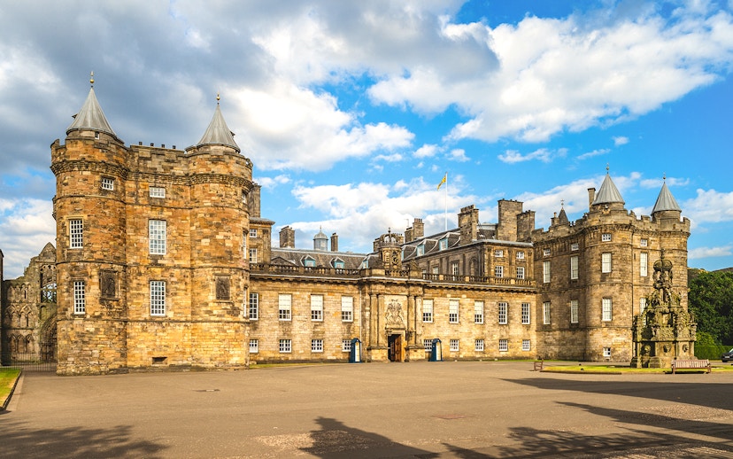 Holyrood Palace in Edinburgh under a blue sky.