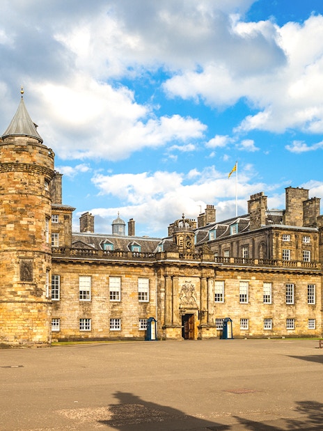Holyrood Palace in Edinburgh under a blue sky.