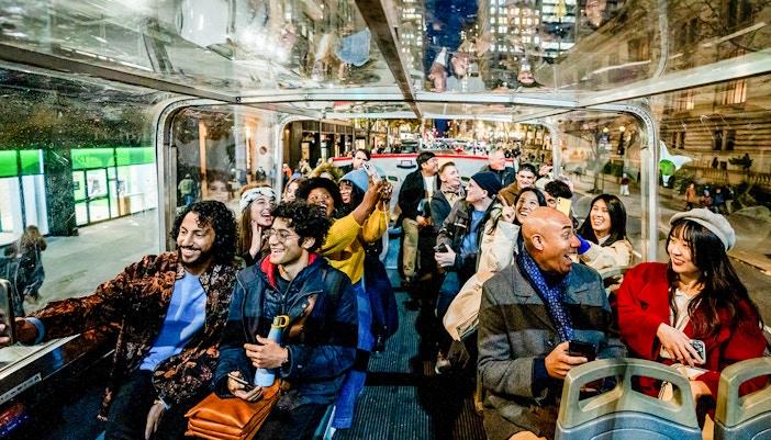 New York City tourists on a Hop On Hop Off bus tour near Times Square.