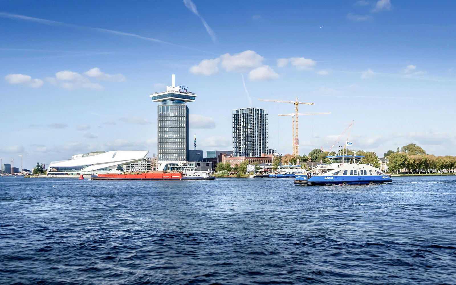 Amsterdam skyline with A'DAM Tower and Eye Film Museum by the river.