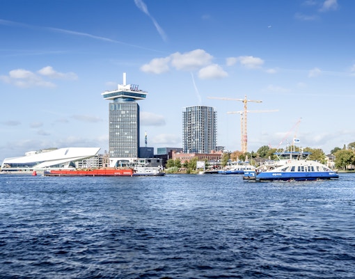 Amsterdam skyline with A'DAM Tower and Eye Film Museum by the river.