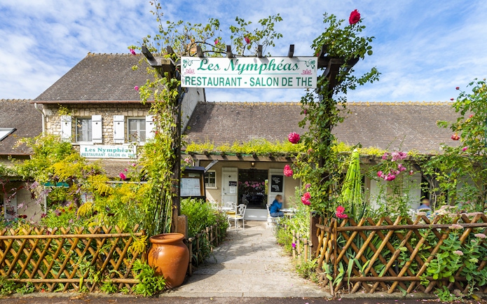 Les Nymphéas restaurant entrance with garden, part of Versailles Palace & Giverny Gardens tour.