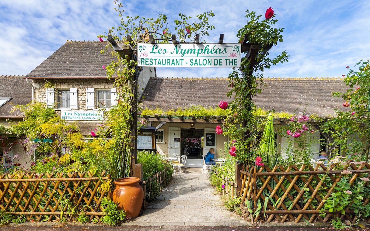 Les Nymphéas restaurant entrance with garden, part of Versailles Palace & Giverny Gardens tour.