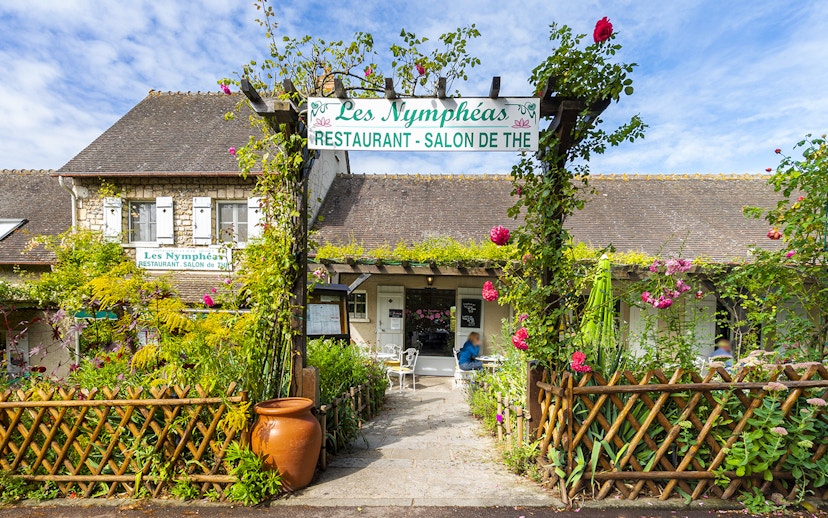Les Nymphéas restaurant entrance with garden, part of Versailles Palace & Giverny Gardens tour.